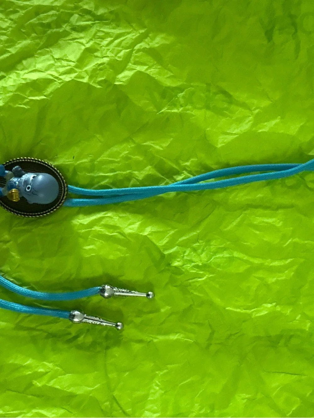 Blue Vinyl Character Figure with Gold Accent Bolo Tie